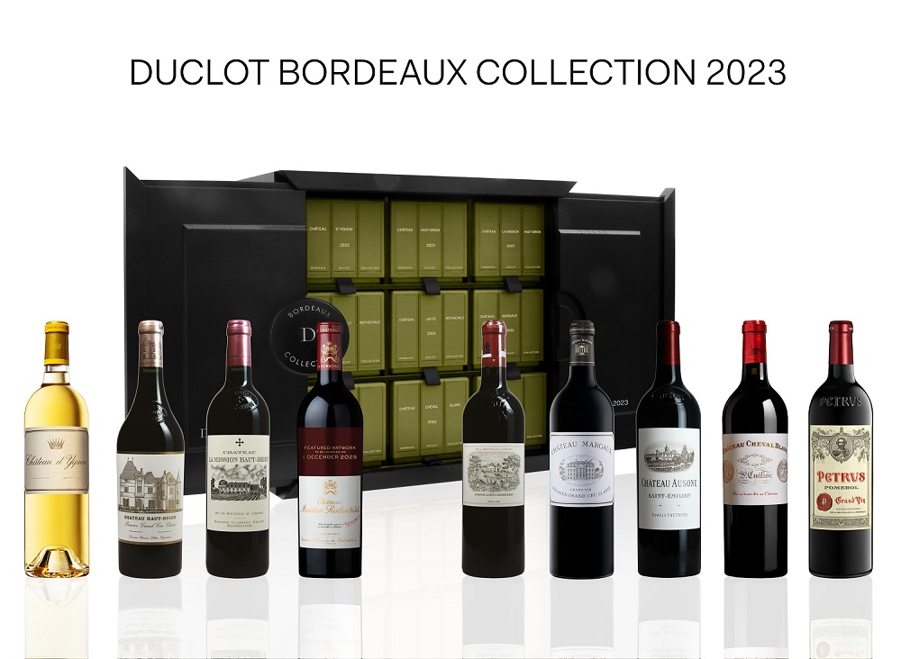 Duclot Sammlerkiste Eine Sammlung edler Weine ist in einer eleganten schwarzen Box präsentiert. Neun Flaschen, darunter Rot- und Weißweine, sind in einem stilvollen Arrangement angeordnet. Die Beschriftung ist gut lesbar.