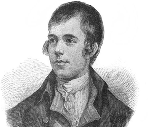 Ein junger Mann mit kurzen, dunklen Haaren und einem schlichten, historischen Anzug schaut nachdenklich. Sein Gesicht zeigt eine leicht ernste Miene, während er vor einem neutralen Hintergrund steht.