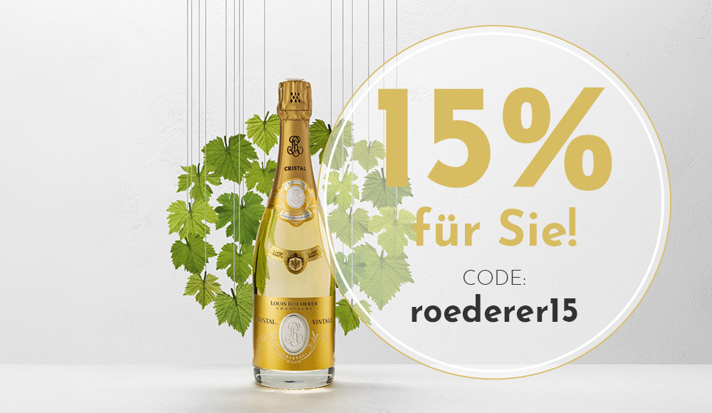 Eine Flasche Champagner mit goldener Etikette steht vor einem weißen Hintergrund, umgeben von grünen Weinblättern. Der Text informiert über 15% Rabatt mit einem Rabattcode.